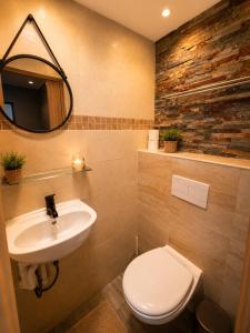 a bathroom with a sink and a toilet and a mirror at Hôtel Faculté in Marseille