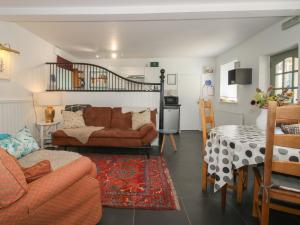 a living room with a couch and a table at Chess Cottage in Hereford