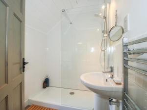a white bathroom with a sink and a shower at Chess Cottage in Hereford +34 photos