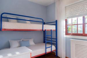 a bedroom with two bunk beds and a window at Villa Aldán Areacova in Aldán +15 photos