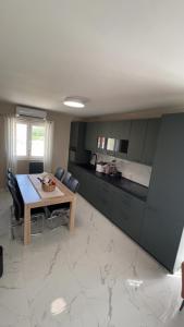 a living room with a table and a kitchen at Villa Smokva in Smoković +12 photos
