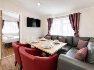 a living room with a table and a couch at Hideaway by Liv Retreats in Lincoln