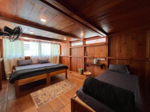a bedroom with two beds and a couch in a room at Yogstel - Backpackers Hostel in Dūta +100 photos