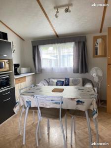 a kitchen with a table and chairs in a room at Thery location 17 in Saint-Pierre-dʼOléron