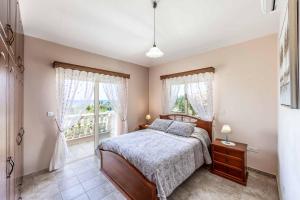 a bedroom with a bed and a window at Villa Vasilissa in Argaka