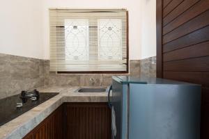 a kitchen with a sink and a refrigerator at Sari Bungalow in Ubud +43 photos
