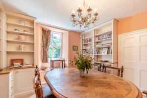 a dining room with a table and chairs and a chandelier at 3 Bed in Castlemorris oc-94522 in Castlemartin +10 photos
