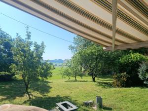 a view of a field from the porch of a house at Appartement Mugron in Mugron