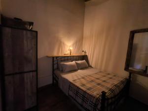 a small bedroom with a bed with a lamp on it at Helidoni in Margarítai