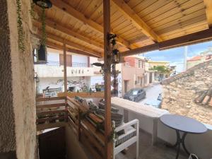 a balcony with a table and a view of a street at Helidoni in Margarítai