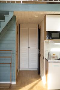 a door leading into a kitchen with a staircase at Zhaltyr resort in Astana
