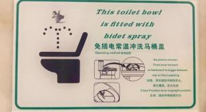 a sign for a toilet bowl with a cat on it at Macau Masters Hotel in Macau +96 photos