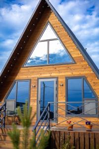 a wooden house with a large window and a deck at Zhaltyr resort in Astana