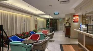 a lobby with chairs and tables in a building at Macau Masters Hotel in Macau