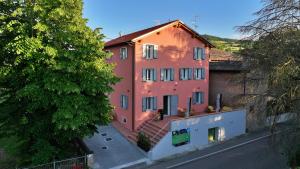 a large pink building with stairs in front of a street at Ca' Lodola in Borzano