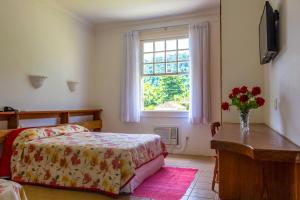 Llit o llits en una habitació de Hotel Fazenda Florença