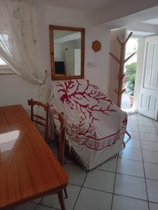 a bedroom with a bed with a mirror and a table at LV SWAN Apartment in Carloforte