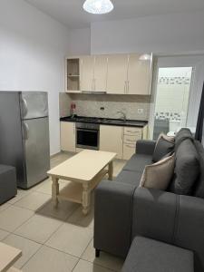 a living room with a couch and a table at Hotel Luis in Durrës