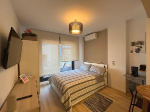 a bedroom with a bed and a television in it at Studio Home Madrid in San Sebastián de los Reyes +28 photos