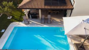 an overhead view of a swimming pool with a house at Villa Lea Marezige Heated Pool near Koper in Marezige