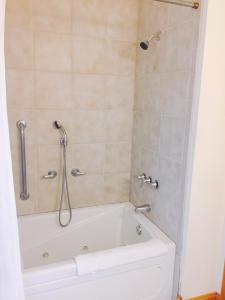 a bathroom with a bath tub with a shower at The Inn on Pamlico Sound in Buxton