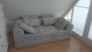 a couch sitting in a living room next to a window at Generations Holiday City Lofts am Neumarkt Kölner Straße 23a in Attendorn
