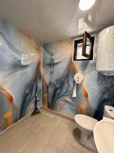 a bathroom with a painting on the wall at Бунгала " SEA VILLAGE DAR " in Kamchia +51 photos