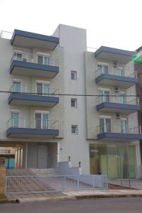 a building with balconies on the side of it at Apartments Holiday in Perea