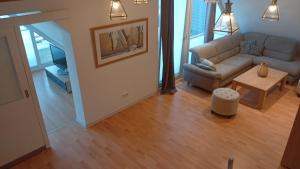 a living room with a couch and a table at Generations Holiday City Lofts am Neumarkt Kölner Straße 23a in Attendorn
