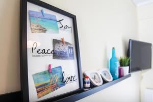 a picture frame on a shelf with pictures on it at Apartments Holiday in Perea