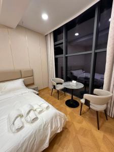 a bedroom with a bed and a table and chairs at Zarya in Ölgiy +6 photos
