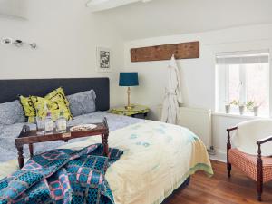 a bedroom with a bed and a table at Apple Bough Cottage in Hereford