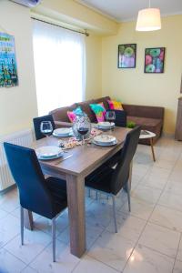 a dining room table with chairs and a couch at Apartments Holiday in Perea
