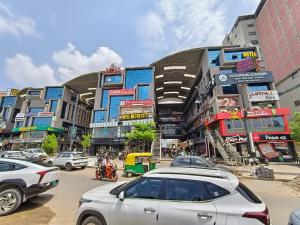 a busy city street with cars and buildings at Hotel Royal Relax in Gandhinagar