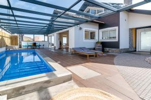 a patio with a swimming pool and a house at Villa Sea Colors by An Island Apart in Arco da Calheta