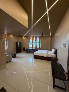 a bedroom with a bed and a living room at JRR room stay in Thiruvaiyāru