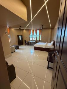 a bedroom with a bed and a living room at JRR room stay in Thiruvaiyāru