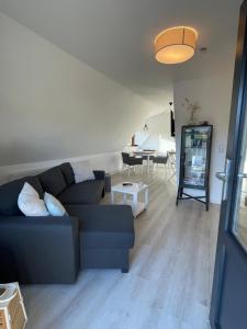 a living room with a couch and a table at Burgerblick in Brodersby