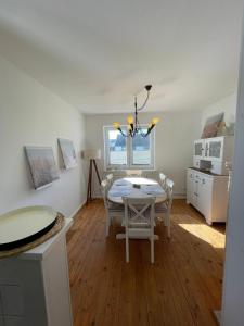 a dining room with a table and chairs at Burgerwiese in Brodersby +12 photos