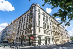 a large white building on the corner of a street at Hotel Caruso Old Town in Prague