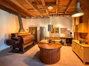 a kitchen with a large wooden table and a stove at Wauermühle in Lohmen