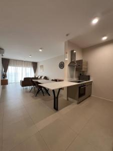 a kitchen and living room with a table and chairs at Nice and calm place in Moka