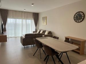 a living room with a table and a couch at Nice and calm place in Moka