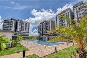 an apartment complex with a swimming pool and some buildings at Nice and calm place in Moka