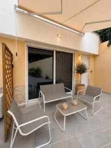 a patio with two chairs and a table at Riviera by Urban Luxy in Athens