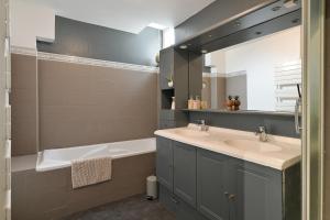a bathroom with a sink and a tub and a mirror at Brunhilde in Montivilliers +19 photos