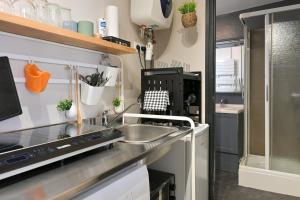 a small kitchen with a sink and a stove at Brunhilde in Montivilliers