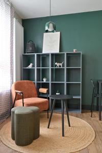 a living room with a chair and a table at Brunhilde in Montivilliers