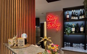 a bar with a sign that says stay fever at DORMERO Hotel Fürth in Fürth +11 photos