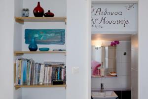 a bathroom with a book shelf with books at Alkistis Apartments, 1st floor in Agios Kirykos